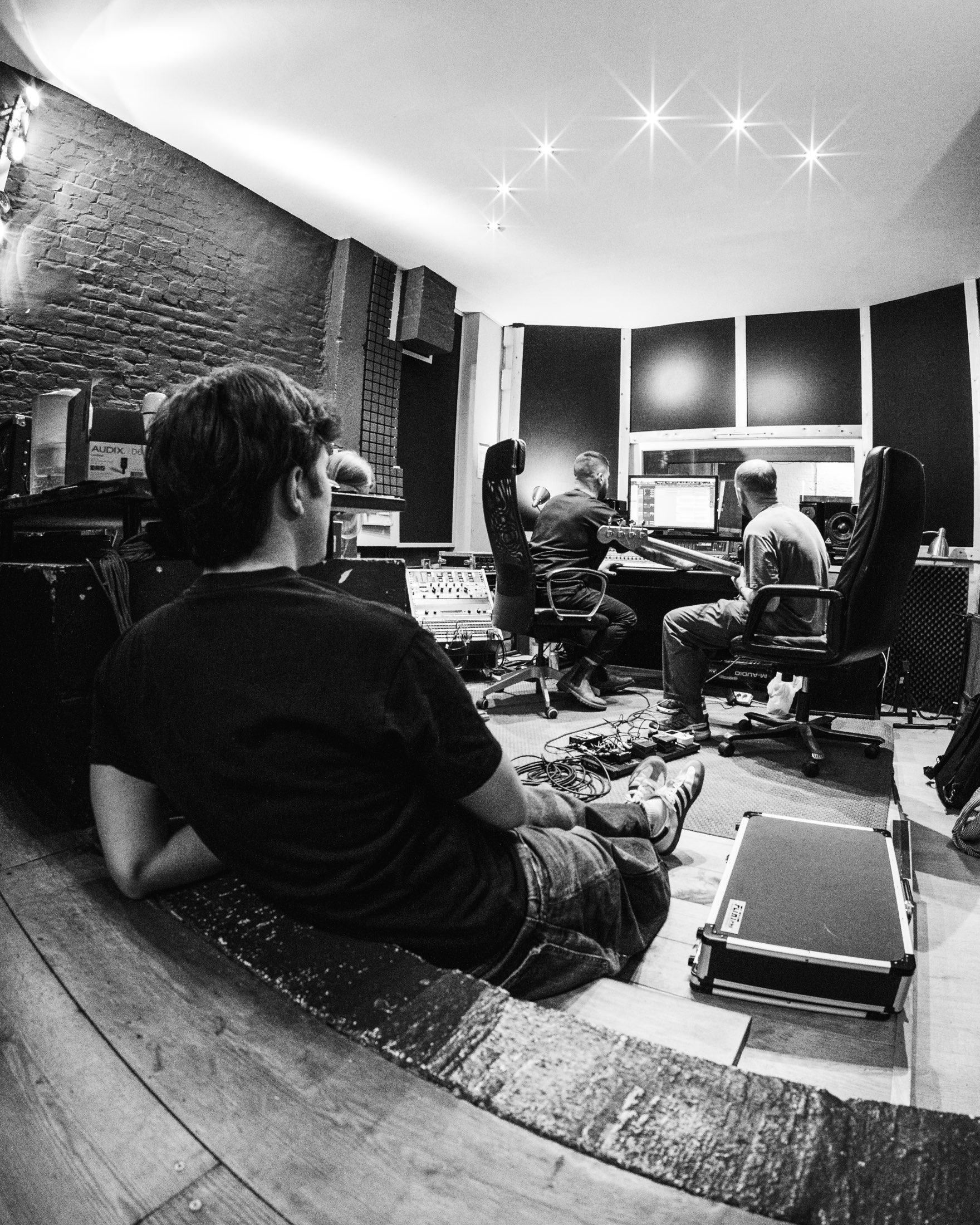 A recording session in progress with artists and collaborators in the studio